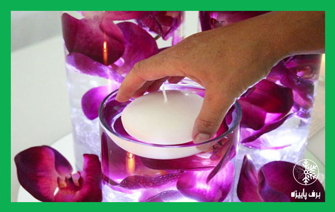 استفاده از ظرف شیشه ای پر از آب برای تزئین شمع
